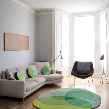 Sonya Winner Jellybean Lime rug, in a modern living room with B&B Italia cream sofa, grey armchair and Grashoppa floor light