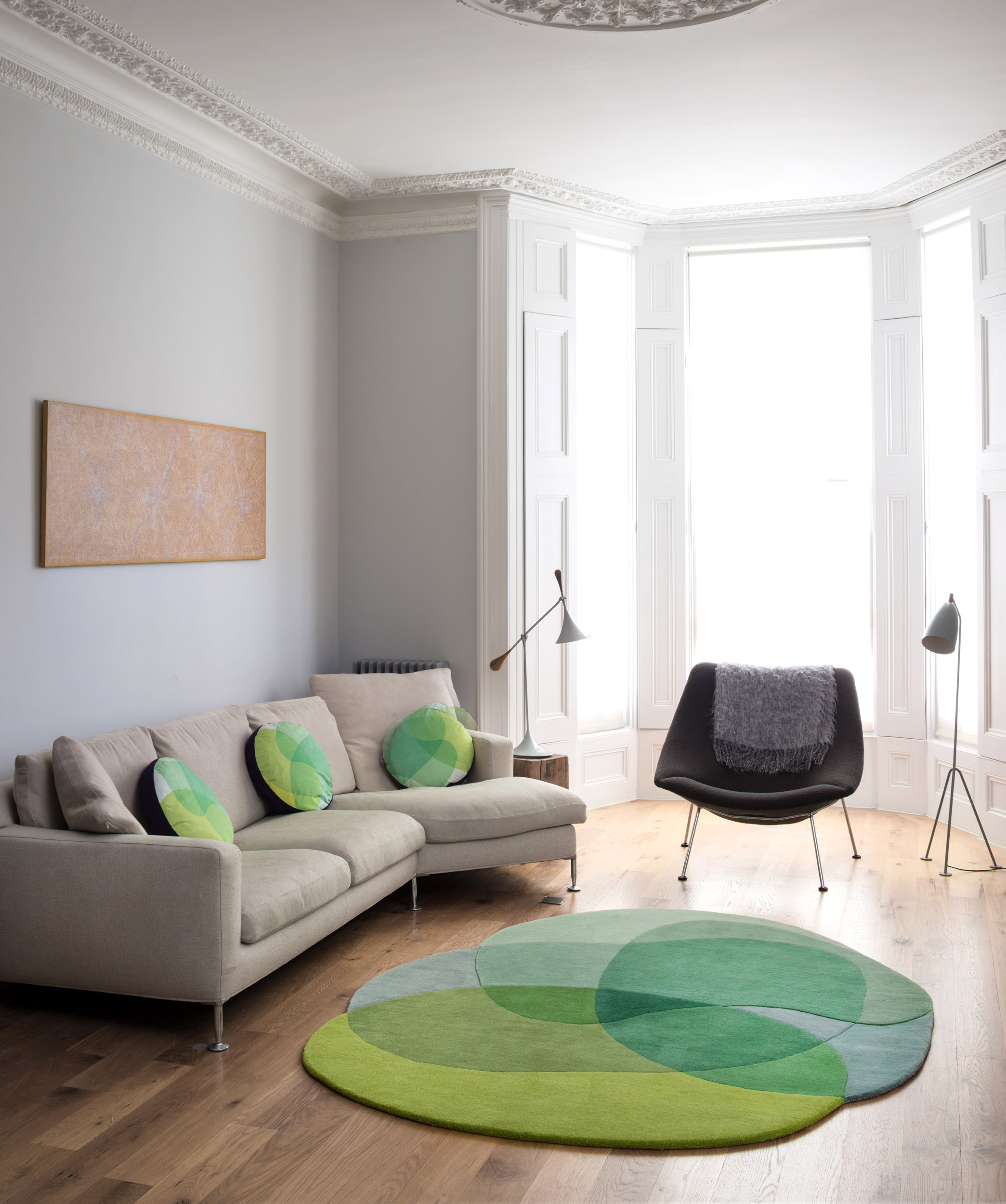 Sonya Winner Jellybean Lime rug, in a modern living room with B&B Italia cream sofa, grey armchair and Grashoppa floor light