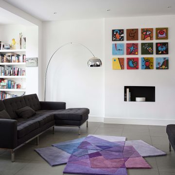 Sonya Winner After Matisse Purple rug shown in a modern living room with B&B Italia black sofa, Arco floor lamp by Achille Castiglioni and colourful abstract wall prints