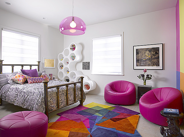 Sonya Winner After Matisse rug shown in a modern colourful kids room with pink leather armchairs, nature patterned bedsheets and white honeycomb bookcase