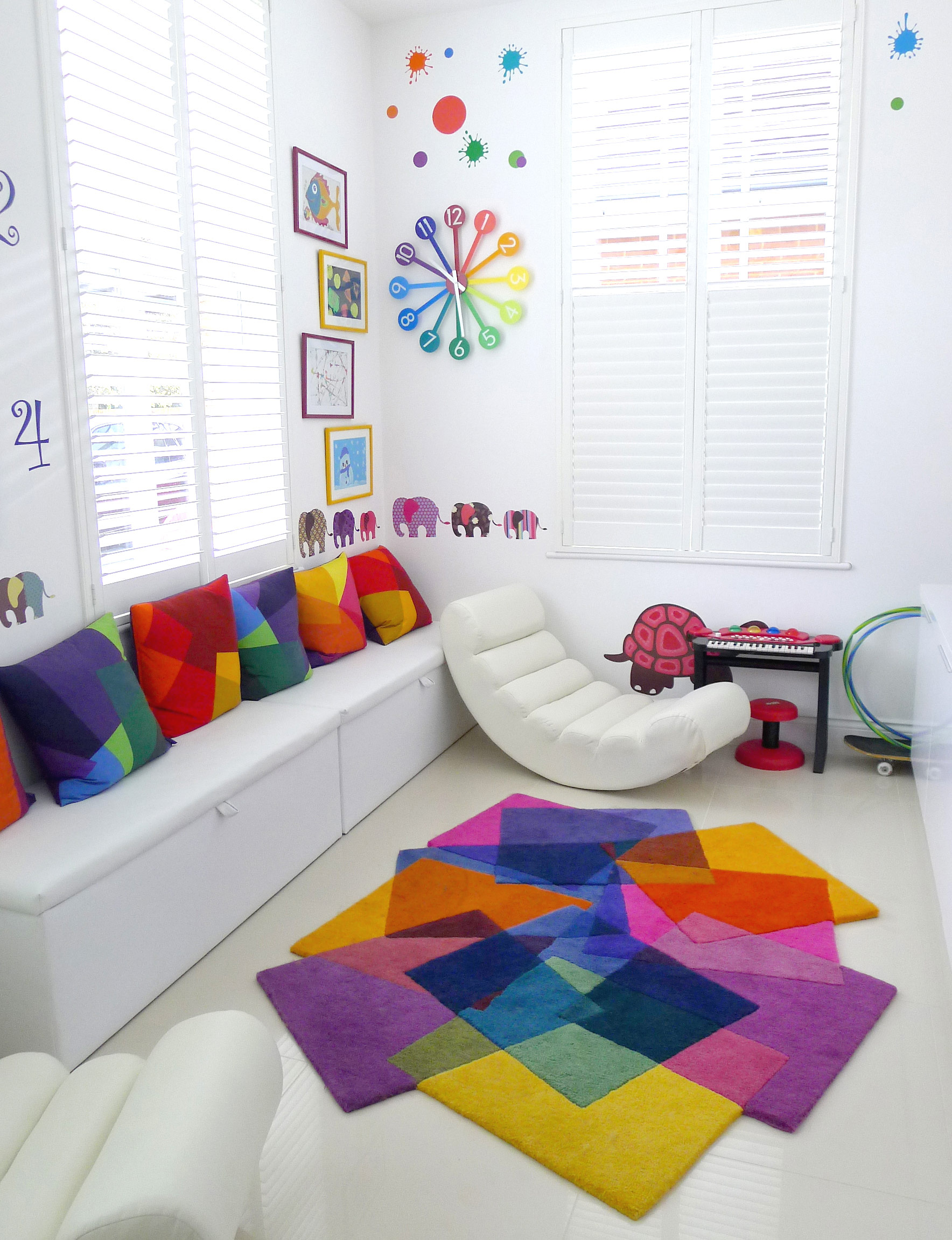 Sonya Winner After Matisse rug shown in a modern colourful playroom with B&B Italia white leather armchair, colourful animals wall stickers and matching Sonya Winner After Matisse cushions set of 5