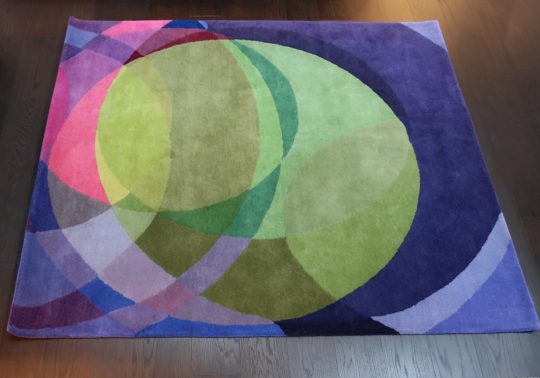 A copped detail image of Sonya Winner Galaxy carpet for sale in a mix of blue, green and purple hues