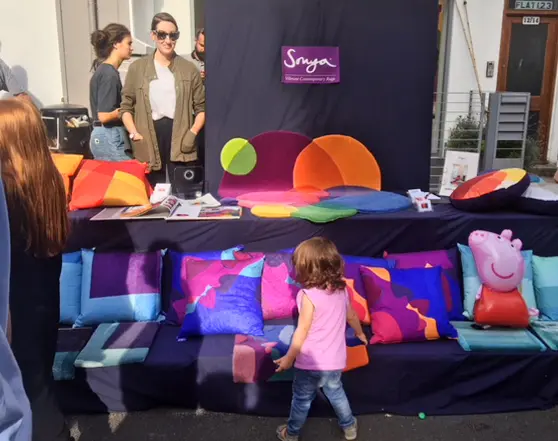 Sonya Winner Studio's commercial stall at York Rise Street Festival, displaying a selection of Sonya's modern colourful rugs and cushions