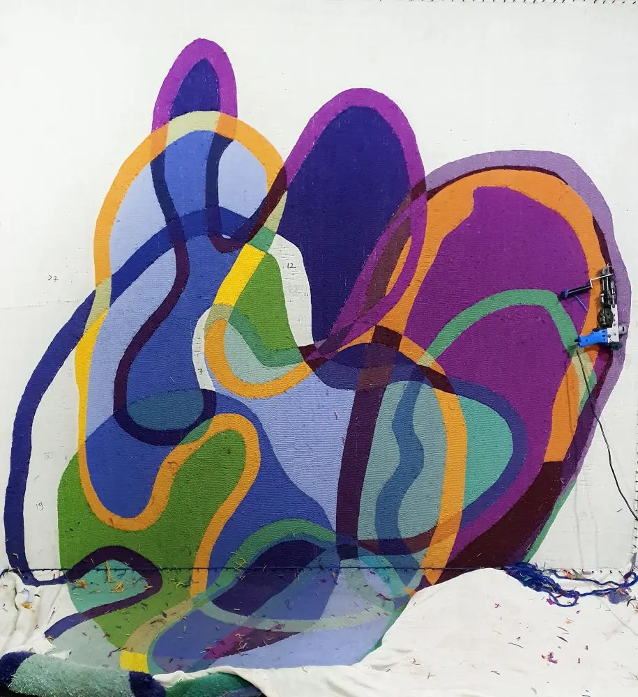 The new Scribble Ink Rug being hand-tufted