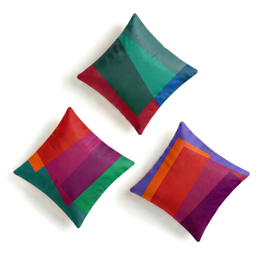 Teal, orange, purple, red, pink and green soft velvet set of 3 cushions on white background