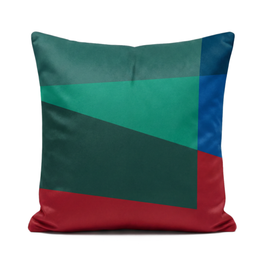 Green, teal, blue and red soft velvet cushion on white background